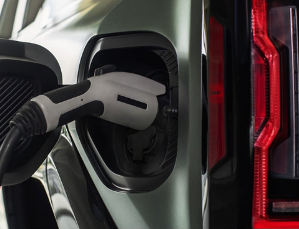 Close up of charging port with charger plugged in on a GMC Hummer EV SUV - Laramie GM Auto Center Inc GMC in Laramie WY